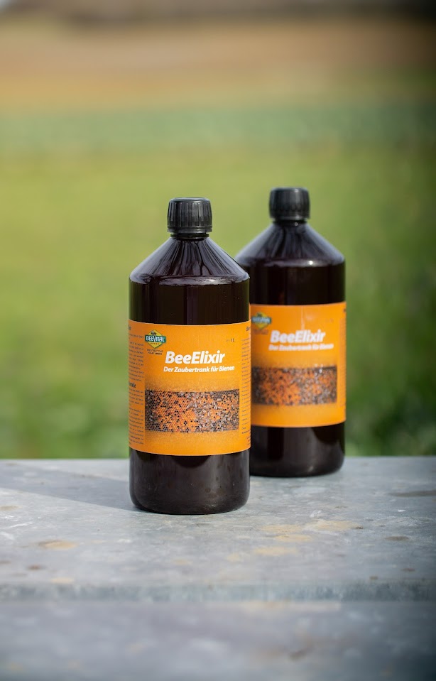 2 bottles of beeelixir standing next to each other close up