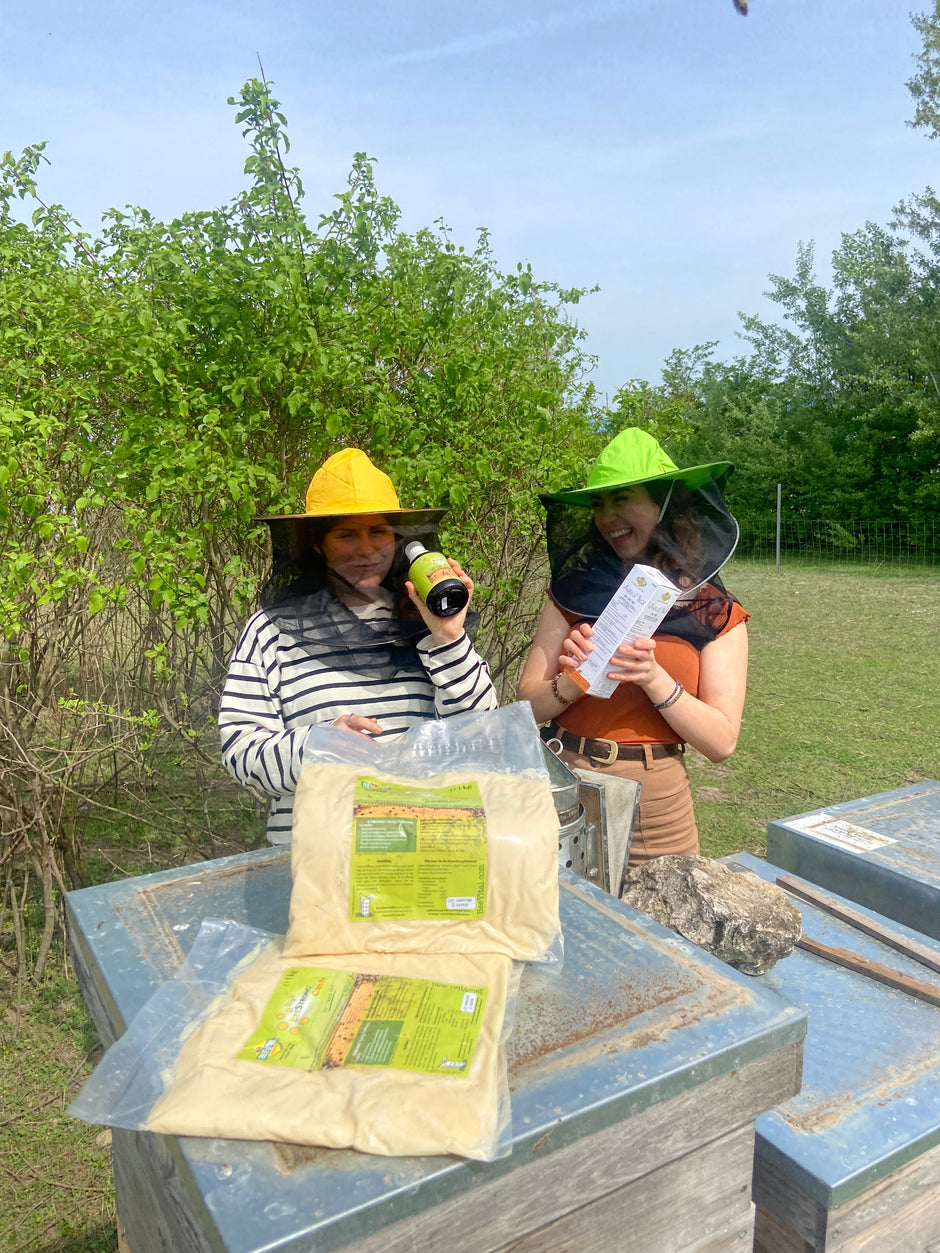 two women happily holding beestrong, varromed with beestrong candy at the foreground