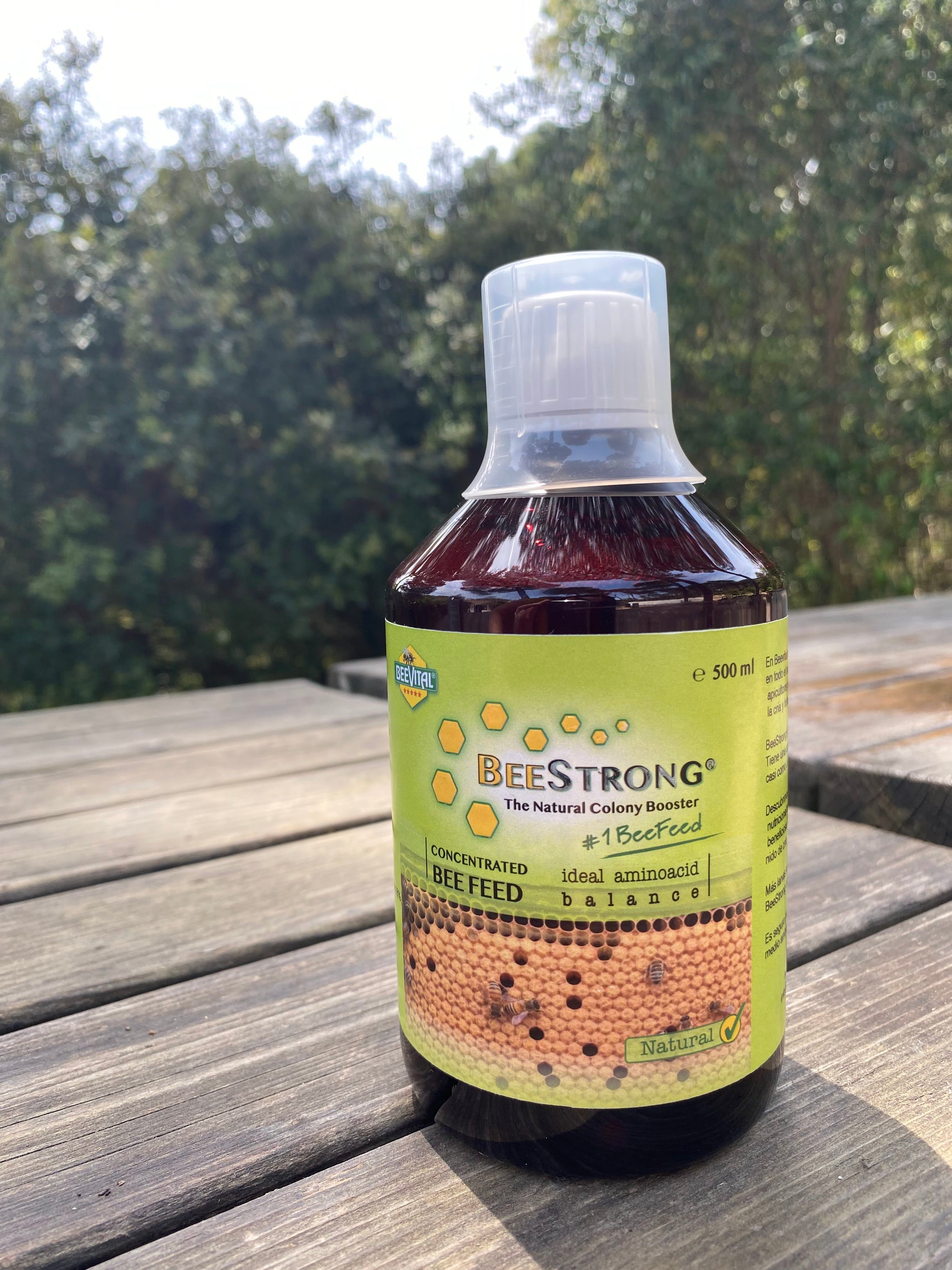 500 ml beestrong bottle on the wooden board , close up