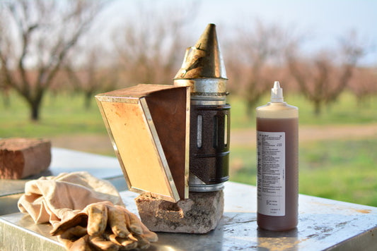 smoker gun and varromed bottle close up with nature background 